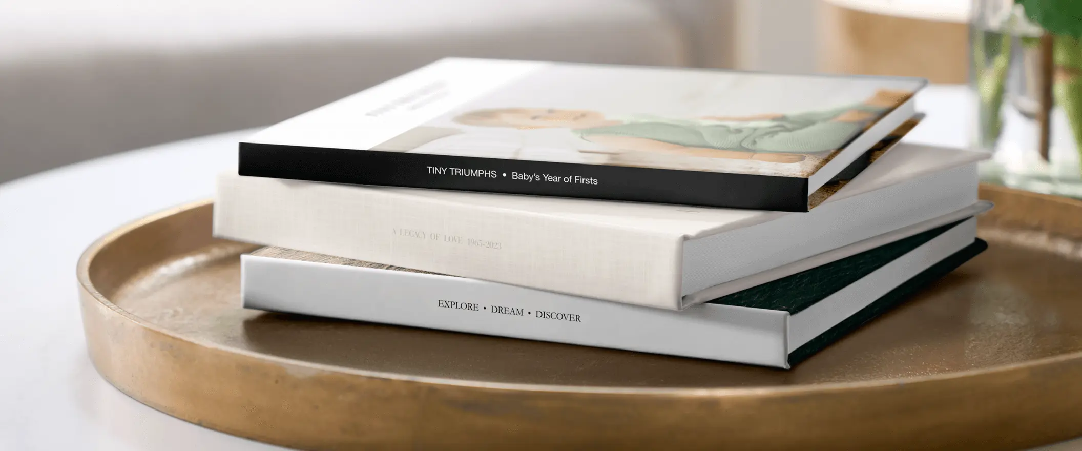 40% off photo books plus unlimited free pages promo with stack of books on gold tray