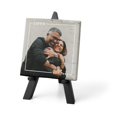 Personalized love tabletop canvas print featuring a couple smiling and hugging one another