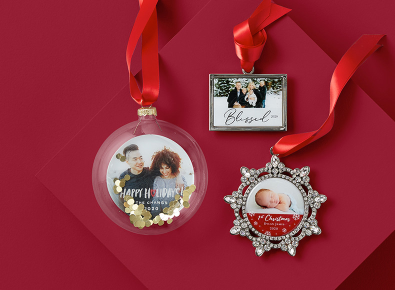 A cube personalized Christmas ornament with pictures of a family and a truck carrying a Christmas tree