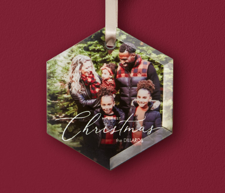 A personalized glass ornament that says Merry Christmas with a photo of a family