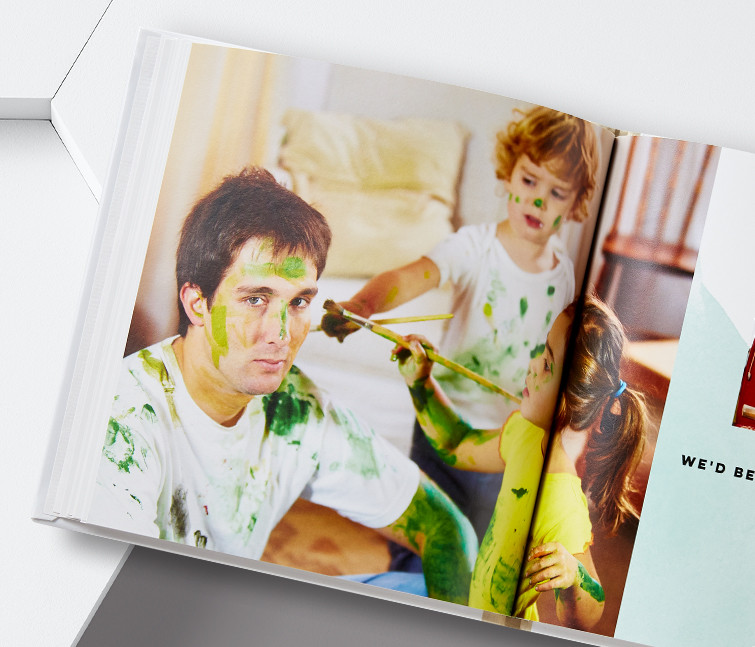 An everyday custom photo book with a picture of kids painting their dad