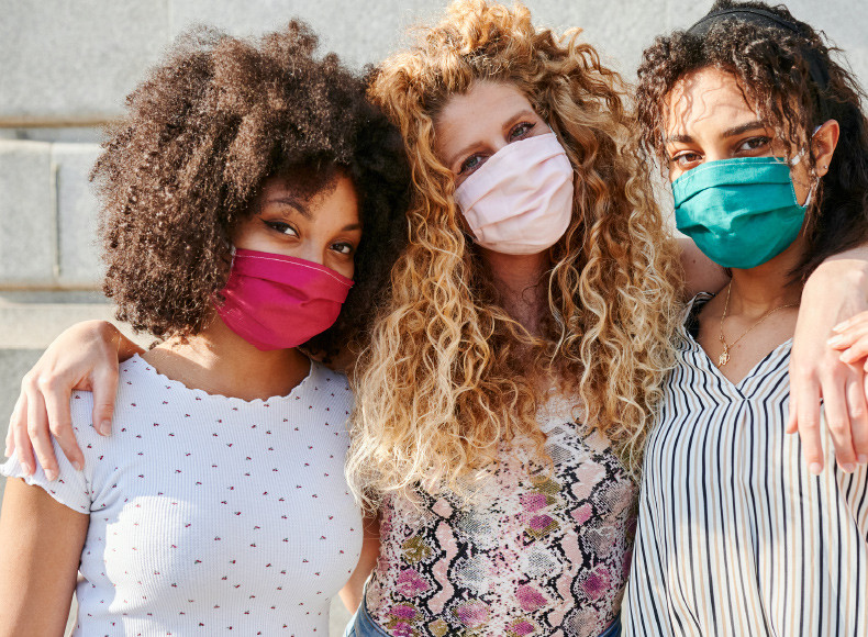 Three friends celebrate Galentine's Day together in custom masks.