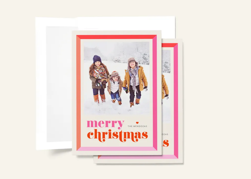 Christmas cards featuring three children walking in snow with colorful border and “Merry Christmas” text.