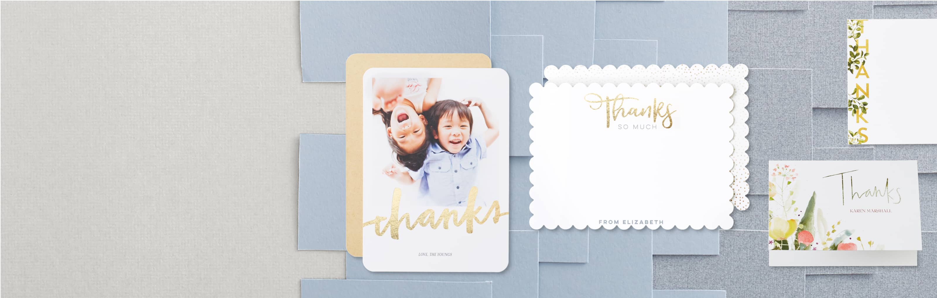 A collection of custom thank you cards with shiny gold lettering